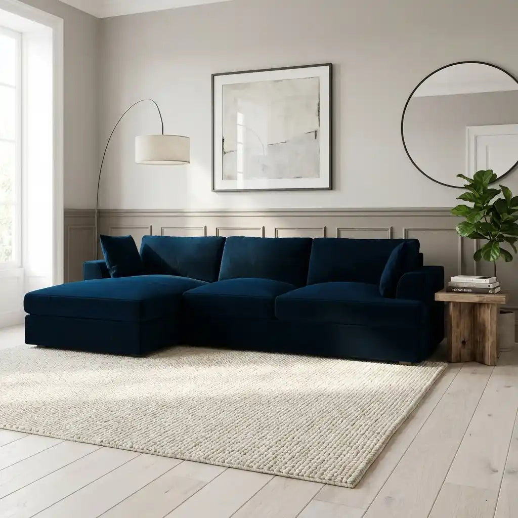 Modern living room with a dark blue sectional sofa, light gray walls, and decorative elements.