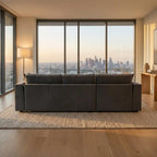 Modern living room with a large sectional sofa and city skyline view.