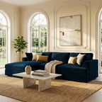 Modern living room with a navy blue sectional sofa, marble coffee table, and abstract art on the wall.