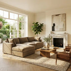 Modern living room with beige sectional sofa, wooden coffee table, and fireplace.