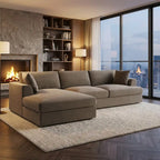 Modern living room with a large sectional sofa, fireplace, and city skyline view.