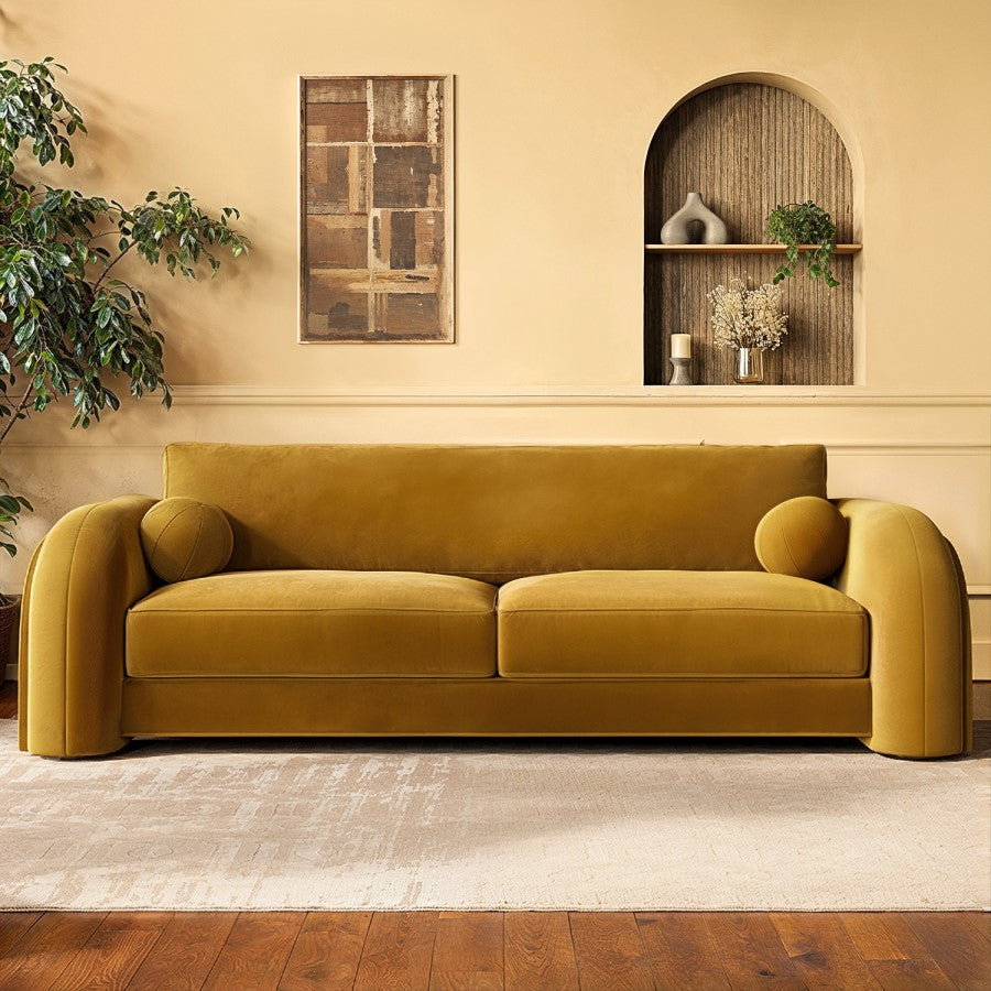 Mustard yellow sofa in a living room with a neutral color palette