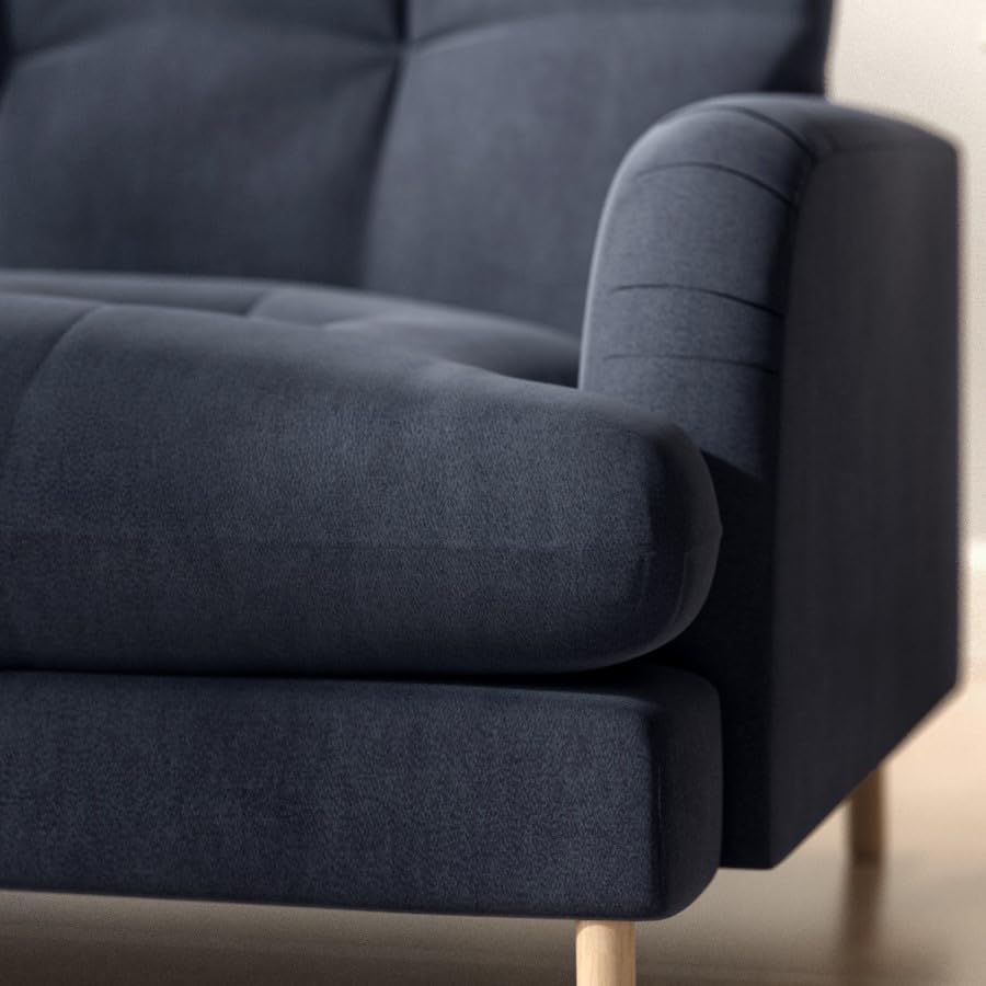 Navy blue sofa with wooden legs in a minimalistic setting