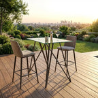 Outdoor dining set with a table and two chairs on a wooden deck with a cityscape in the background.