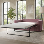 Pink sofa bed in a room with large windows and a plant.