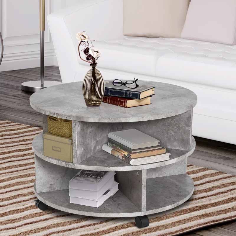 Round concrete coffee table with books and decor items in a living room setting