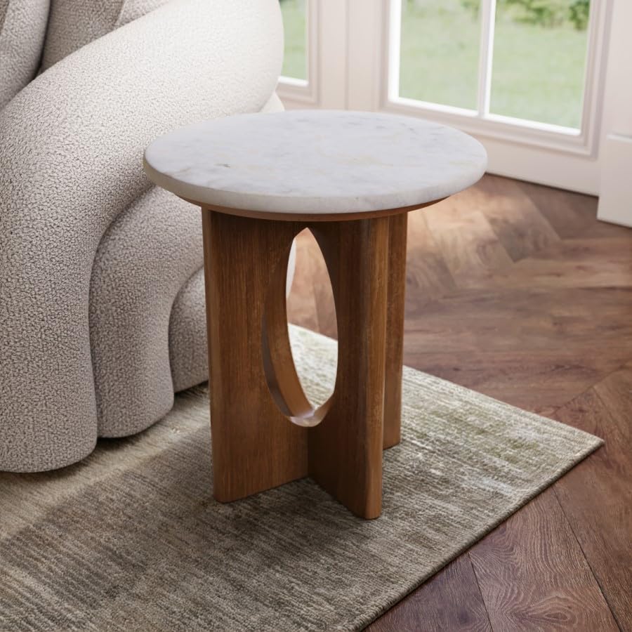 Small round wooden side table with marble top in a living room setting.
