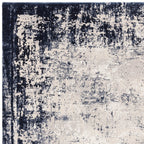 Textured area rug with a mix of black, gray, and beige colors.