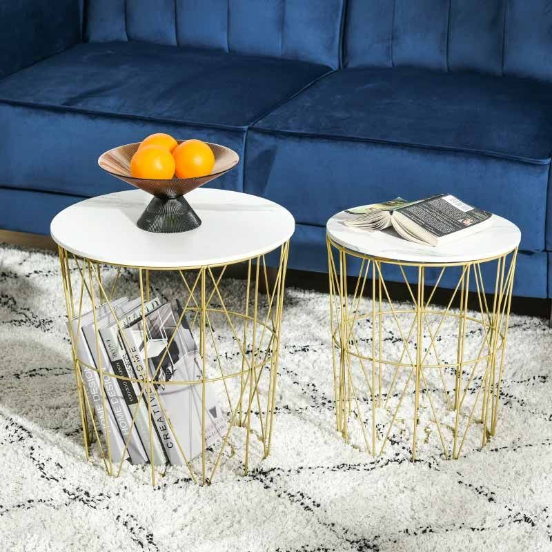 Two marble top side tables with gold metal bases in a living room setting.