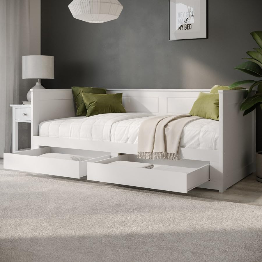 White bed with storage drawers in a bedroom setting