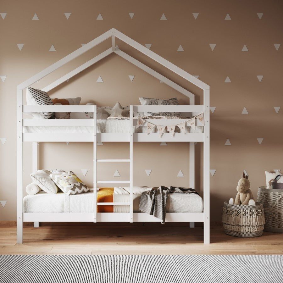 White children's house-shaped bunk bed in a room with beige walls and decorative triangles.
