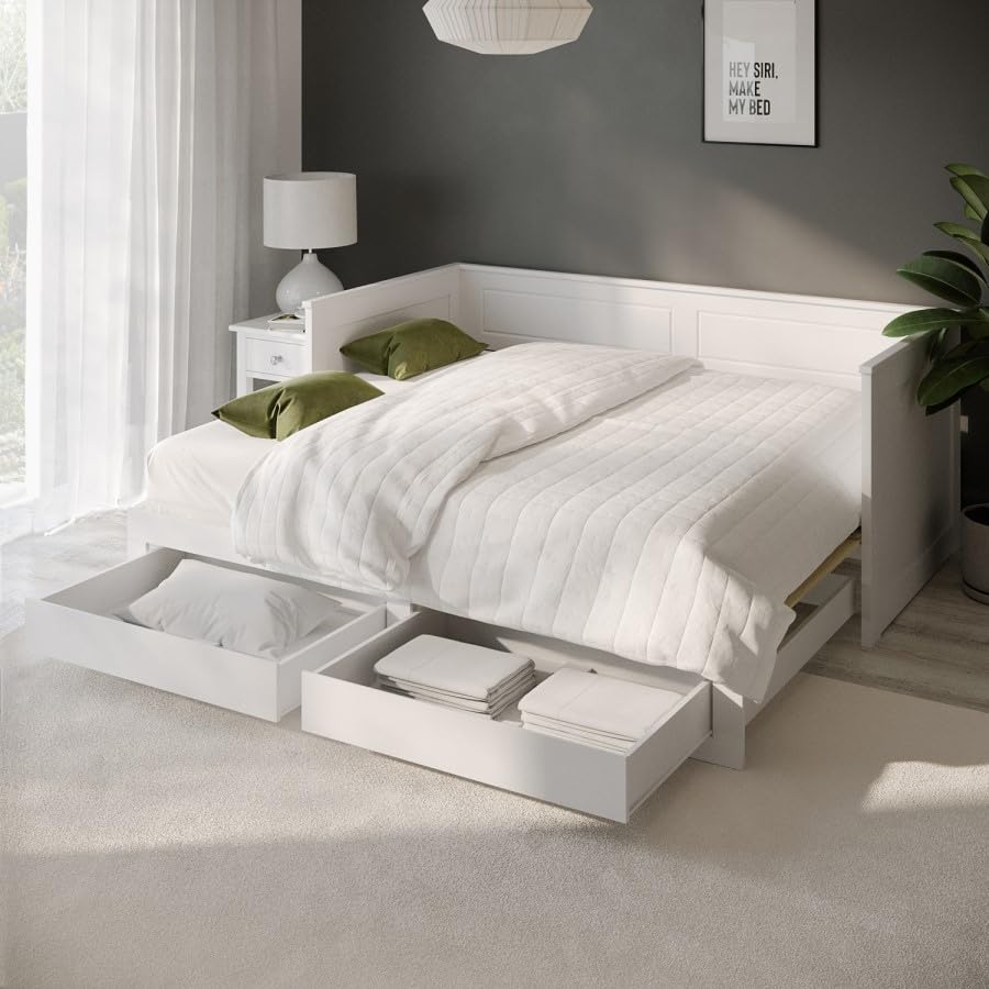 White bed with storage drawers in a modern bedroom setting