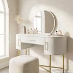 White vanity table with gold legs and a round mirror in a bright room.