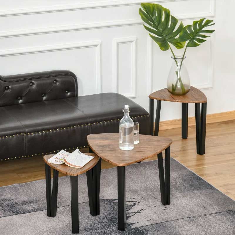 Wooden side tables with black legs in a living room setting.