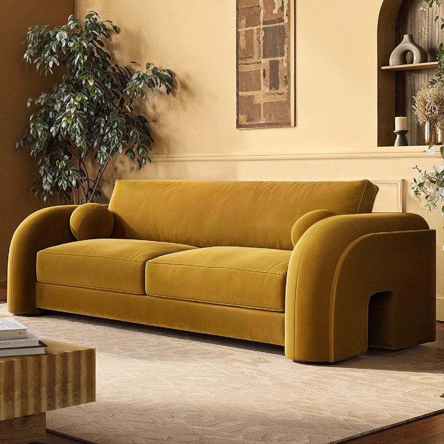 Yellow sofa in a living room setting with decor elements.