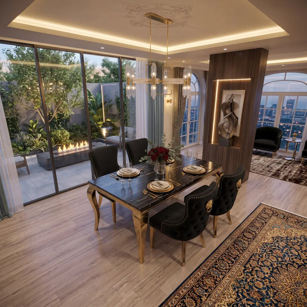 A luxury modern dining room featuring a rectangular black marble-top dining table with gold legs, surrounded by black tufted velvet chairs. The room has light wood floors, a large patterned oriental rug, a glass wall overlooking a green outdoor patio, and a sophisticated ceiling with recessed LED lighting.
