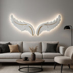 Modern living room with a large feather wall sculpture, gray sofa, and round coffee table.