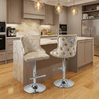 Two bar stools with quilted seats in a modern kitchen.