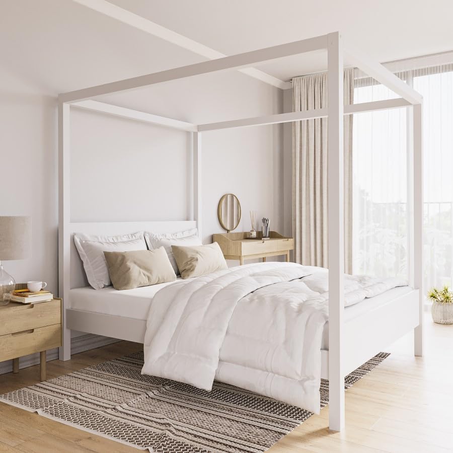 Modern bedroom with a canopy bed, white bedding, and wooden nightstands.
