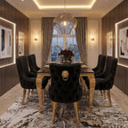 An elegant dining room featuring a black tufted velvet dining table set with six matching high-back chairs. The chairs have gold legs and a prominent gold lion-head knocker on the backrest.