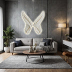 Modern living room with a gray sofa, round coffee table, and decorative butterfly wall art.