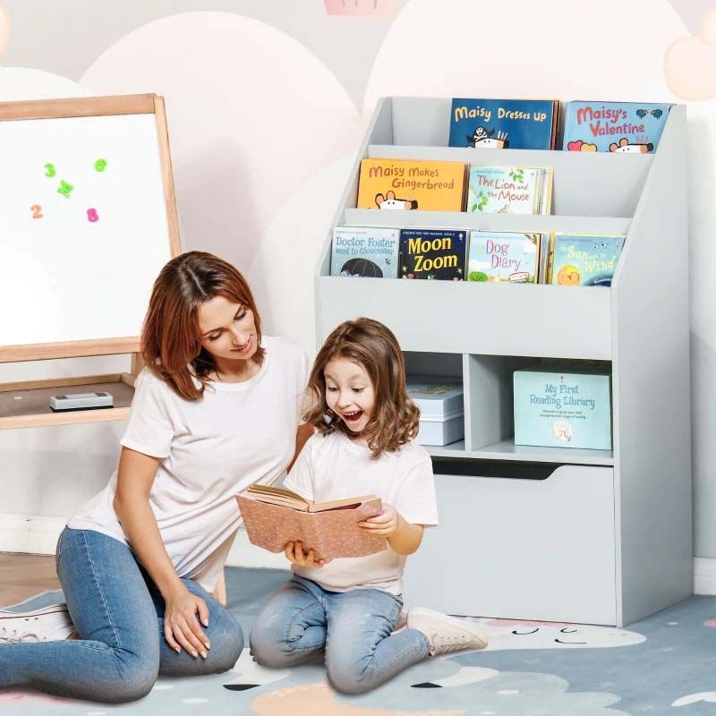 Woman and child reading a book in front of a bookshelf filled with children's books.