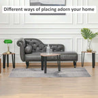 Gray tufted sofa in a living room setting with decor items.