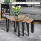 Stackable coffee tables with a vase of flowers on a living room floor.