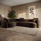 A dark brown curved modular sectional sofa with matching throw pillows, styled in a modern living room