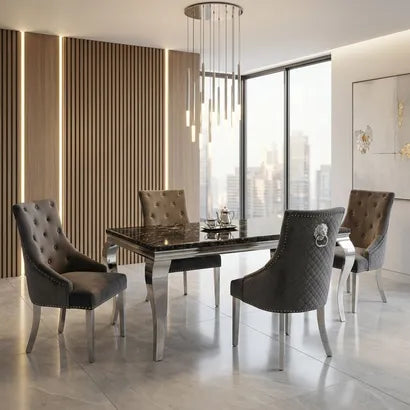 A modern dining room set featuring a rectangular black marble-top table with a polished silver frame, surrounded by four tufted upholstered dining chairs in gray and taupe tones, set in a contemporary room with a city view.