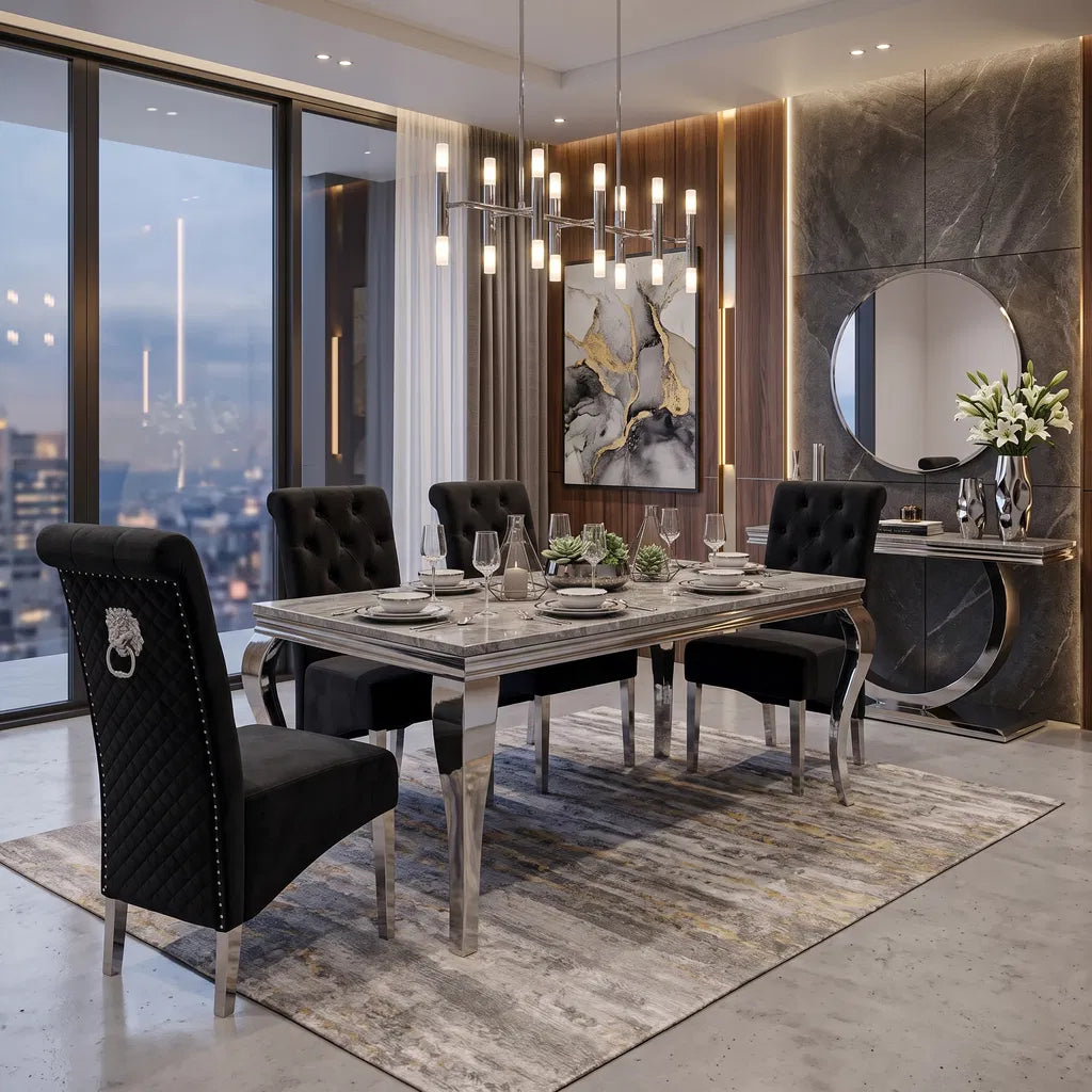 A luxury modern dining room set featuring a rectangular marble-top dining table with silver legs, surrounded by four black tufted velvet chairs with silver accents. The set is styled on a textured gray and gold patterned rug in a high-end contemporary dining room with a city view, a round wall mirror, and a chandelier.
