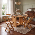 A light natural wood dining table set with four matching folding chairs, styled on a patterned area rug in a bright, traditional dining room.