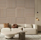 Living room with a geometric patterned wall, beige sofa, and decorative items.