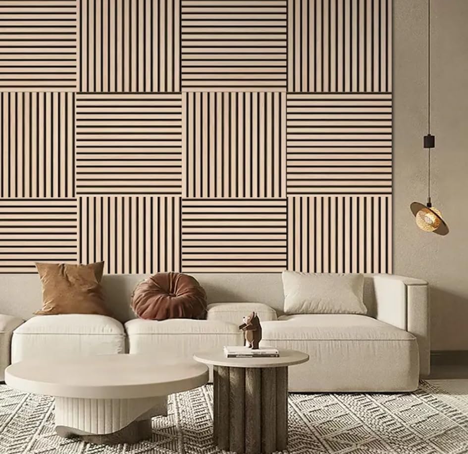 Living room with a geometric patterned wall, beige sofa, and decorative items.