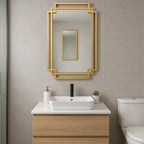  gold-framed mirror on a tiled wall.