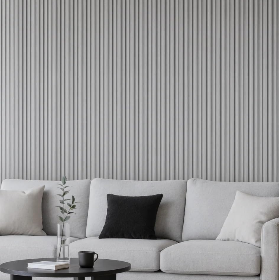 Gray sofa with decorative pillows against a gray striped wall