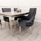 Dining table set with black chairs in a room with light wood flooring and white walls.