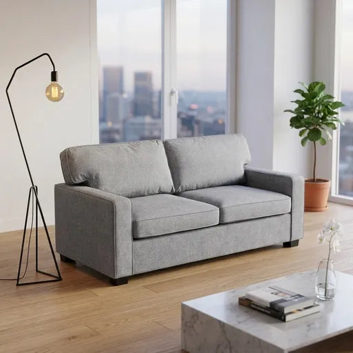 A light gray two-seater loveseat sofa in a modern living room 