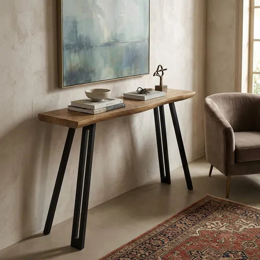 A long console table with a natural wood top and black angled metal legs