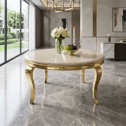 A round marble-top dining table with ornate gold legs