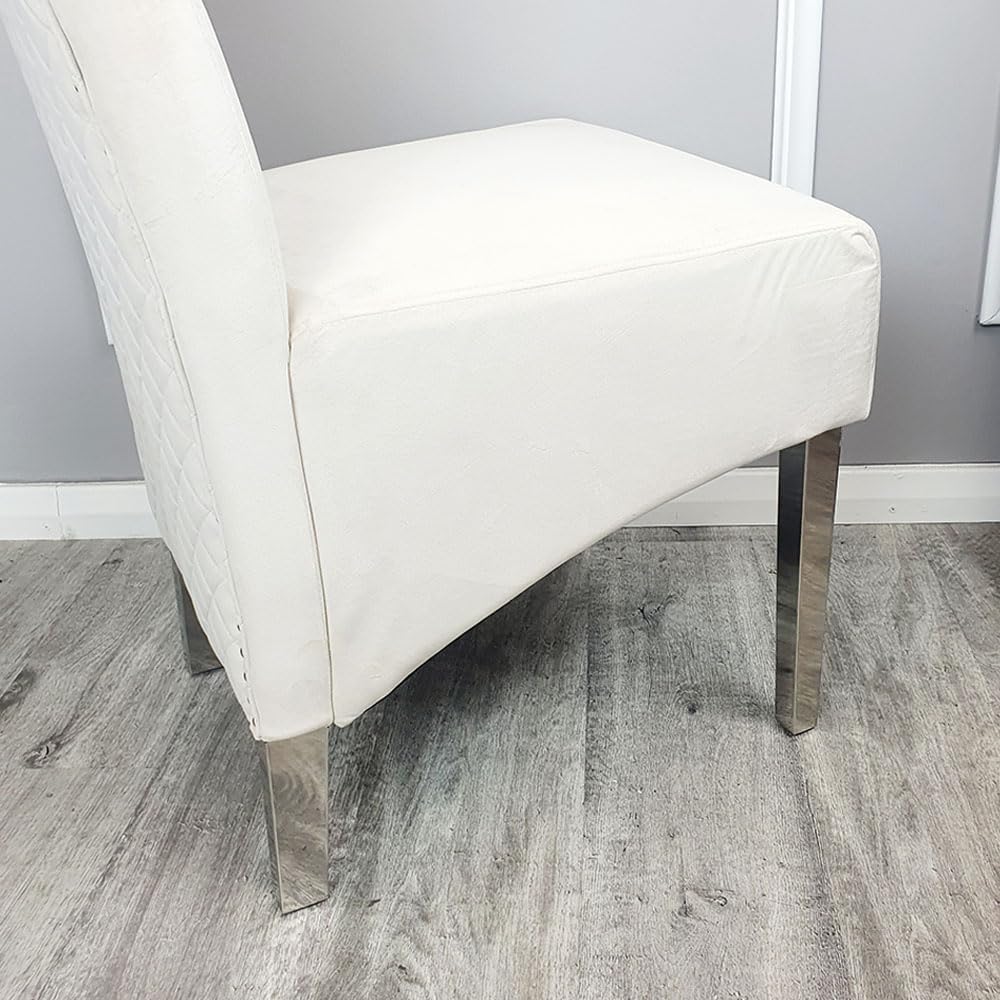 Cream chair with chrome legs on a wooden floor against a gray wall