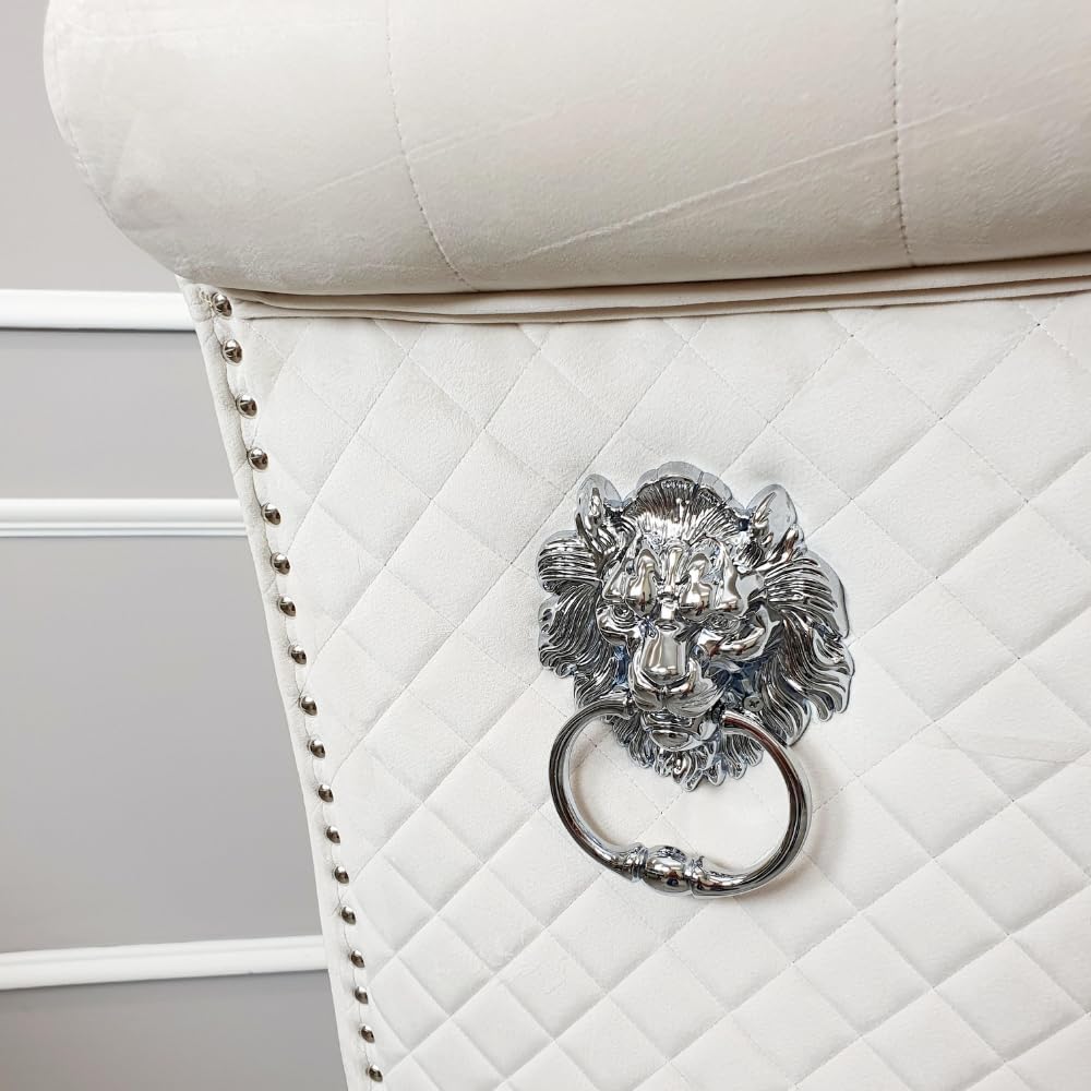 Cream upholstered chair with a decorative lion head knocker on a neutral background