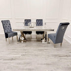 Dining table set with four gray chairs on a wooden floor.