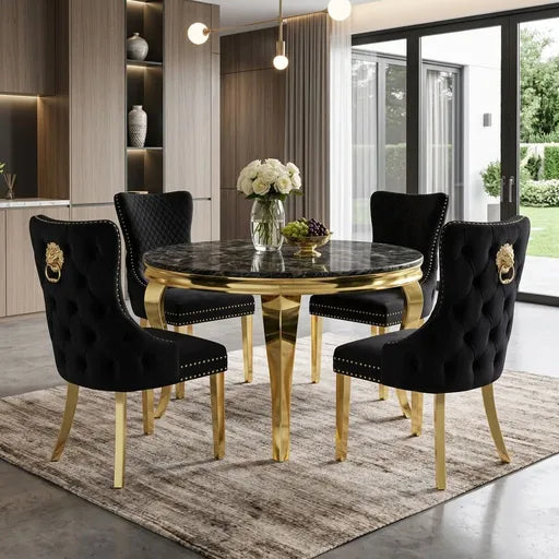 A luxury 5-piece dining set featuring a round black marble-top table with a polished gold base, surrounded by four black tufted velvet chairs with gold legs and lion head hardware.