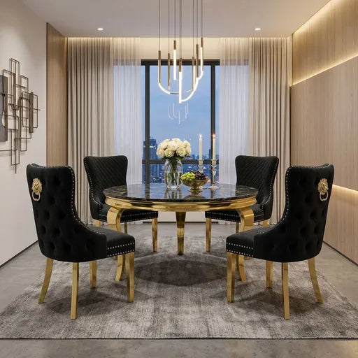 A luxury dining room set featuring a round black marble-top dining table with a gold base, surrounded by four black tufted velvet chairs with gold legs and lion head backrests, set on a gray rug in a modern room.