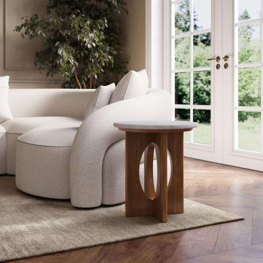 Modern living room with a white sofa, wooden side table, and large windows.
