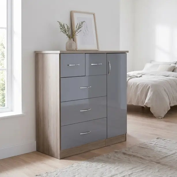 A modern 5-drawer chest of drawers in a gray and light wood finish, styled in a bright bedroom next to a window with a framed print and vase on top.