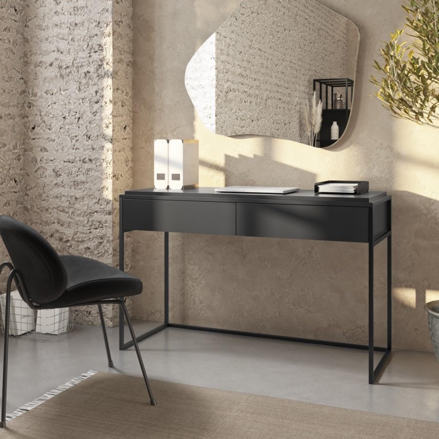 Modern black desk with a chair in a stylish room with a mirror and decorative elements.
