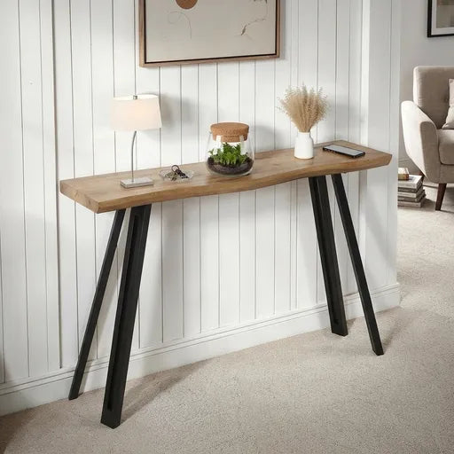 A modern console table with a natural wood top and black metal A-frame legs, 
