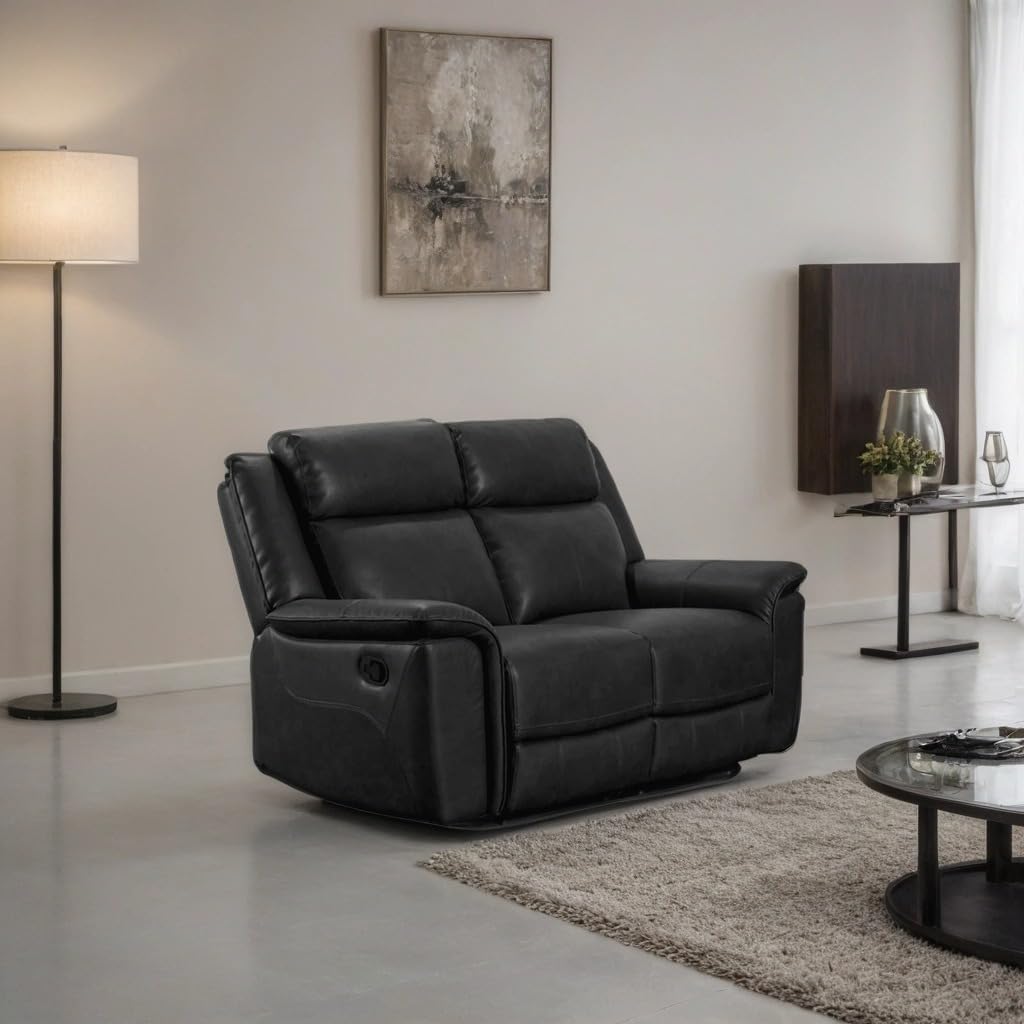 Black leather recliner sofa in a modern living room setting with a lamp and wall art.